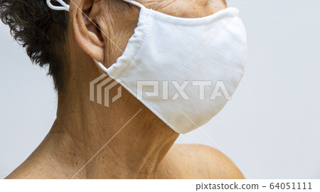 Senior woman wearing DIY handmade cotton cloth mask Medical mask, Surgical mask in white background, Side view, Close up shot, Select focus, Prevention from covid19, Coronavirus, Bacteria, Healthcare Senior woman wearing DIY handmade cotton cloth mask Medical mask, Surgical mask in white background, Side view, Close up shot, Select focus, Prevention from covid19, Coronavirus, Bacteria, Healthcare 64051111