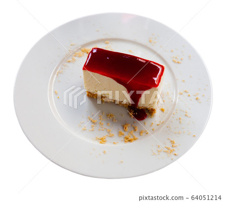 Slice of delicious classical cheesecake with fruity sauce served in cafeteria Slice of delicious classical cheesecake with fruity sauce served in cafeteria 64051214