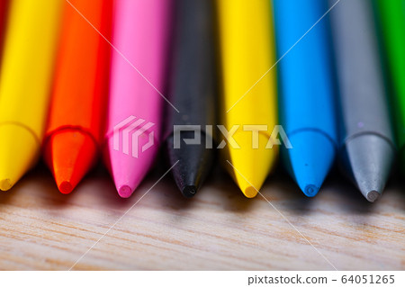 Set of multicolored wax crayons on wooden surface 64051265