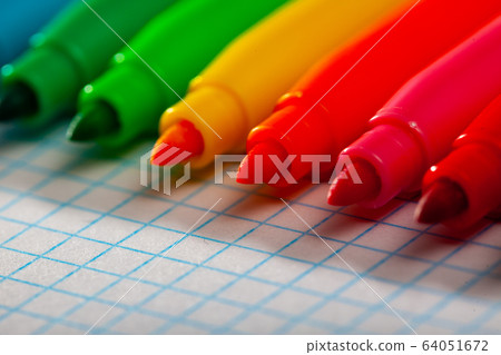 Set of multicolored felt tip on checkered sheet of paper 64051672