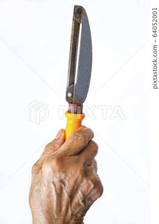 Senior woman's right hand holding Stainless with plastic orange peeler on white background, Close up shot, Selective focus, Kitchen utensils concept 64052001