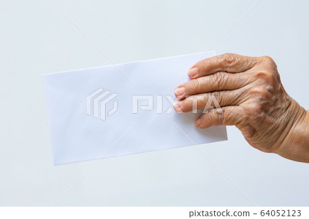 Senior woman's right hand holding white envelope or bride isolated on white background, Close up and macro shot, Business concept Senior woman's right hand holding white envelope or bride isolated on white background, Close up and macro shot, Business concept 64052123