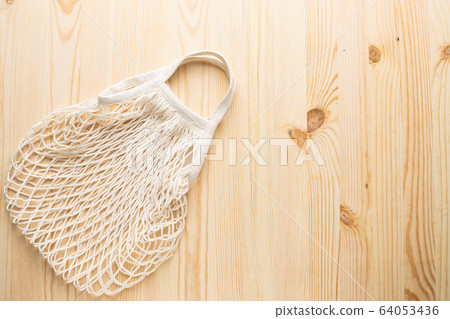 Cotton shopping eco friendly bag on wooden background, zero waste and plastic free concept. 64053436