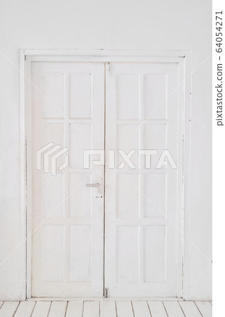 Old-style white wooden door. interior apartment. Wooden floor made of planks Old-style white wooden door. interior apartment. Wooden floor made of planks 64054271