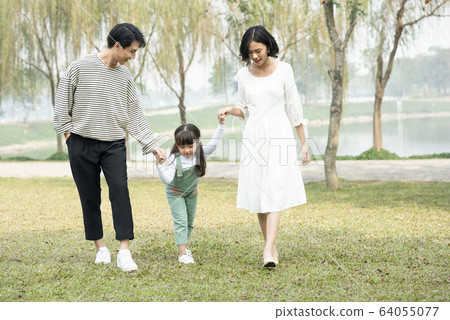 Parents walking in the park 64055077