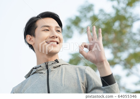 Young man exercising outdoors Young man exercising outdoors 64055346
