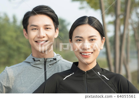 Men and women exercising outdoors Men and women exercising outdoors 64055561