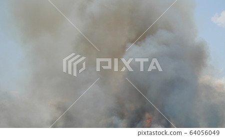 Blurry black with gray and brown smoke or steam on blue background, Pollution and burning Blurry black with gray and brown smoke or steam on blue background, Pollution and burning 64056049