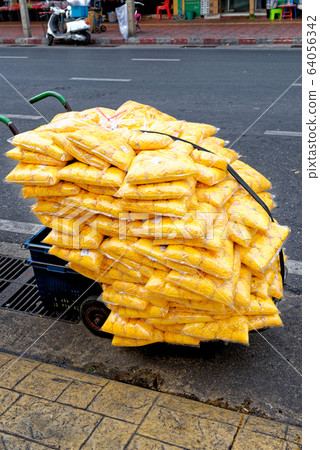 Plastic bags full of cut flowers 64056342