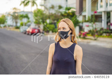 Fashionable black medical mask with filter in the city. Coronavirus 2019-ncov epidemic concept Fashionable black medical mask with filter in the city. Coronavirus 2019-ncov epidemic concept 64059119