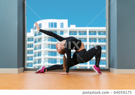 woman leaned back by the window 64059175