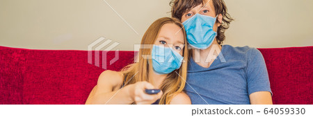 Man and woman are sitting in quarantine, sitting at home and watching TV. Coronavirus, epidemic 64059330