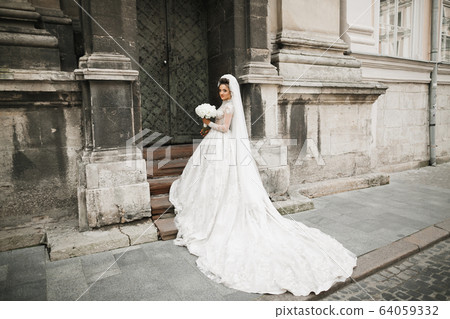 Bride holding big and beautiful wedding bouquet with flowers 64059332