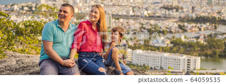 Happy family tourists on the background of Nha Trang city. Travel to Vietnam with kids Concept 64059535