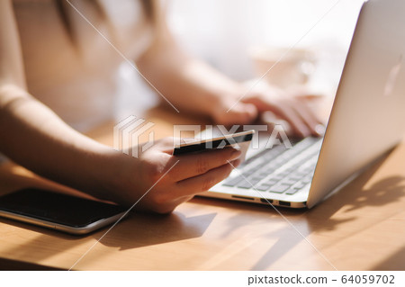 Business woman working from home. Female wearing protective mask. Woman in quarantine, covid-19. Working from home. Cleaning her hands with sanitizer gel. Stay Home 64059702