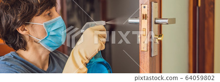 Coronovirus Prevention A man disinfects a doorknob. Closeup of a caucasian man disinfecting the door 64059802
