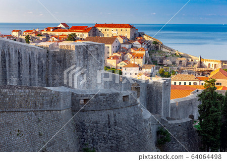 Dubrovnik. Old city walls and towers in the early morning. 64064498
