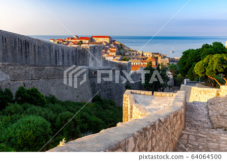Dubrovnik. Old city walls and towers in the early morning. 64064500