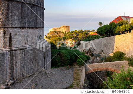 Dubrovnik. Old city walls and towers in the early morning. 64064501
