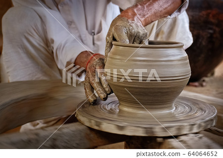 Indian potter at work, Shilpagram, Udaipur, Rajasthan, India Indian potter at work, Shilpagram, Udaipur, Rajasthan, India 64064652