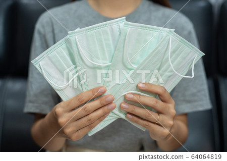 women holding lot antivirus medical face masks women holding lot antivirus medical face masks 64064819