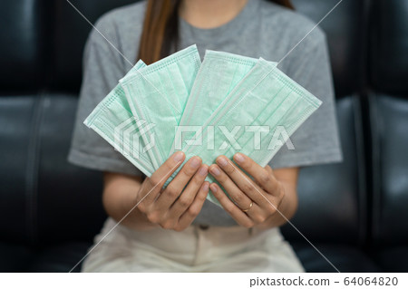 women holding lot antivirus medical face masks women holding lot antivirus medical face masks 64064820