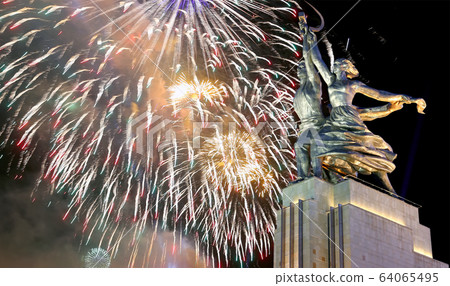 Soviet monument Rabochiy i Kolkhoznitsa ( Worker and Kolkhoz Woman) of sculptor Vera Mukhina (made of in 1937)  and fireworks in honor of Victory Day celebration (WWII), Moscow, Russia 64065495