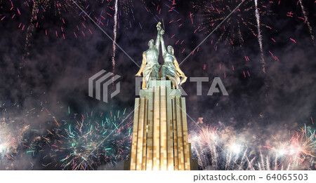 Soviet monument Rabochiy i Kolkhoznitsa ( Worker and Kolkhoz Woman) of sculptor Vera Mukhina (made of in 1937)  and fireworks in honor of Victory Day celebration (WWII), Moscow, Russia 64065503