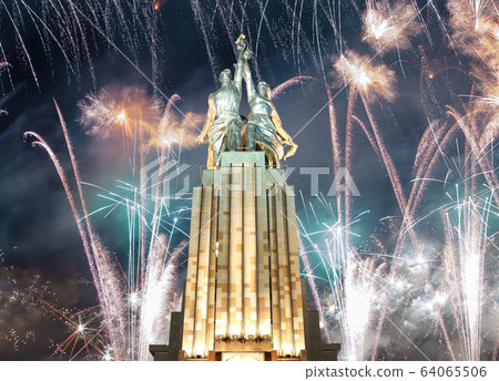Soviet monument Rabochiy i Kolkhoznitsa ( Worker and Kolkhoz Woman) of sculptor Vera Mukhina (made of in 1937)  and fireworks in honor of Victory Day celebration (WWII), Moscow, Russia 64065506