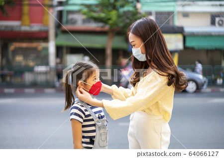 Asian beautiful woman and her daughter wear protection mask 64066127
