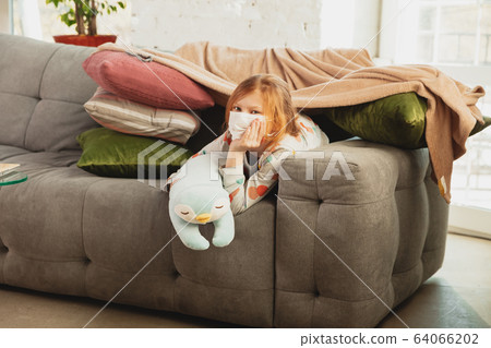 Little girl in protective mask isolated at home with coronavirus symptoms, stop epidemic Little girl in protective mask isolated at home with coronavirus symptoms, stop epidemic 64066202