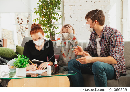 Caucasian family in protective masks and gloves isolated at home with coronavirus symptoms, treatment Caucasian family in protective masks and gloves isolated at home with coronavirus symptoms, treatment 64066239