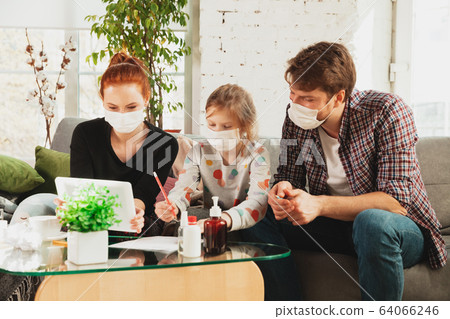 Caucasian family in protective masks and gloves isolated at home with coronavirus symptoms, treatment Caucasian family in protective masks and gloves isolated at home with coronavirus symptoms, treatment 64066246