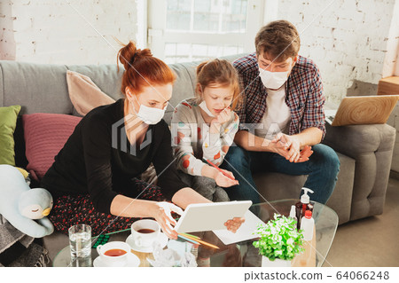 Caucasian family in protective masks and gloves isolated at home with coronavirus symptoms, treatment Caucasian family in protective masks and gloves isolated at home with coronavirus symptoms, treatment 64066248