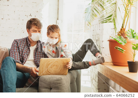 Father and daughter in protective masks and gloves isolated at home with coronavirus symptoms, stop epidemic 64066252