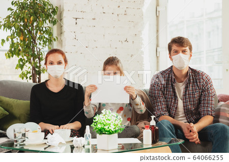 Caucasian family in protective masks and gloves isolated at home with coronavirus symptoms, stop epidemic 64066255