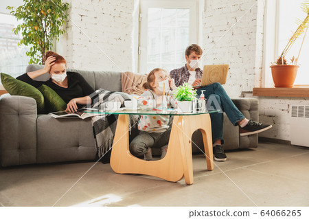 Caucasian family in protective masks and gloves isolated at home with coronavirus symptoms, treatment Caucasian family in protective masks and gloves isolated at home with coronavirus symptoms, treatment 64066265