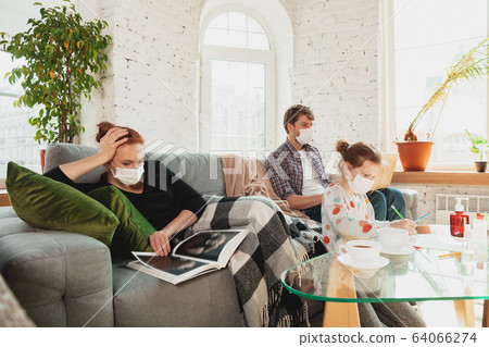 Caucasian family in protective masks and gloves isolated at home with coronavirus symptoms, treatment Caucasian family in protective masks and gloves isolated at home with coronavirus symptoms, treatment 64066274