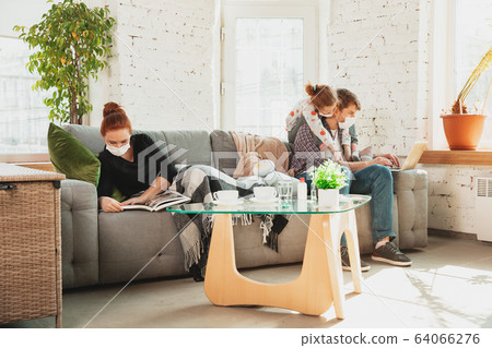 Caucasian family in protective masks and gloves isolated at home with coronavirus symptoms, treatment 64066276