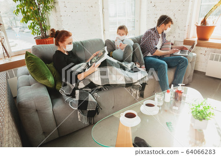 Caucasian family in protective masks and gloves isolated at home with coronavirus symptoms, treatment Caucasian family in protective masks and gloves isolated at home with coronavirus symptoms, treatment 64066283