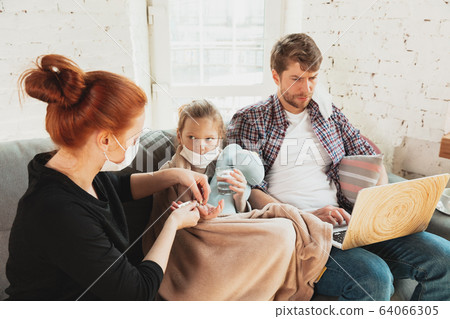 Caucasian family in protective masks and gloves isolated at home with coronavirus symptoms, treatment Caucasian family in protective masks and gloves isolated at home with coronavirus symptoms, treatment 64066305