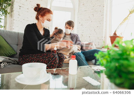 Caucasian family in protective masks and gloves isolated at home with coronavirus symptoms, treatment 64066306