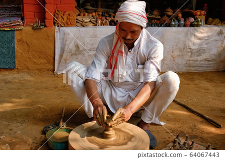Indian potter at work, Shilpagram, Udaipur, Rajasthan, India Indian potter at work, Shilpagram, Udaipur, Rajasthan, India 64067443