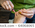 Step-by-step pedicure at home. Lift the cuticle from the nail using an orange stick or a manicure spatula. The concept of caring for toenails 64068065