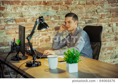 Man working from home during coronavirus or COVID-19 quarantine, remote office concept 64068876