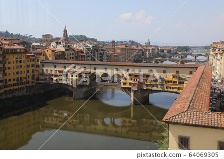 Florence, Italy - 2020. View of bridge Ponte Vecchio over Arno river. Florence, Italy - 2020. View of bridge Ponte Vecchio over Arno river. 64069305