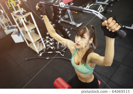 Young sport woman working out in gym. Healthy with 64069515