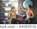 Young sport woman making Hi-5 with happy at gym. 64069516