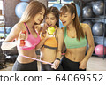 Portrait of happy young sport woman friends in gym. 64069552