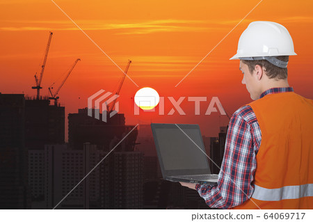 Engineer builder with laptop computer at Engineer builder with laptop computer at 64069717